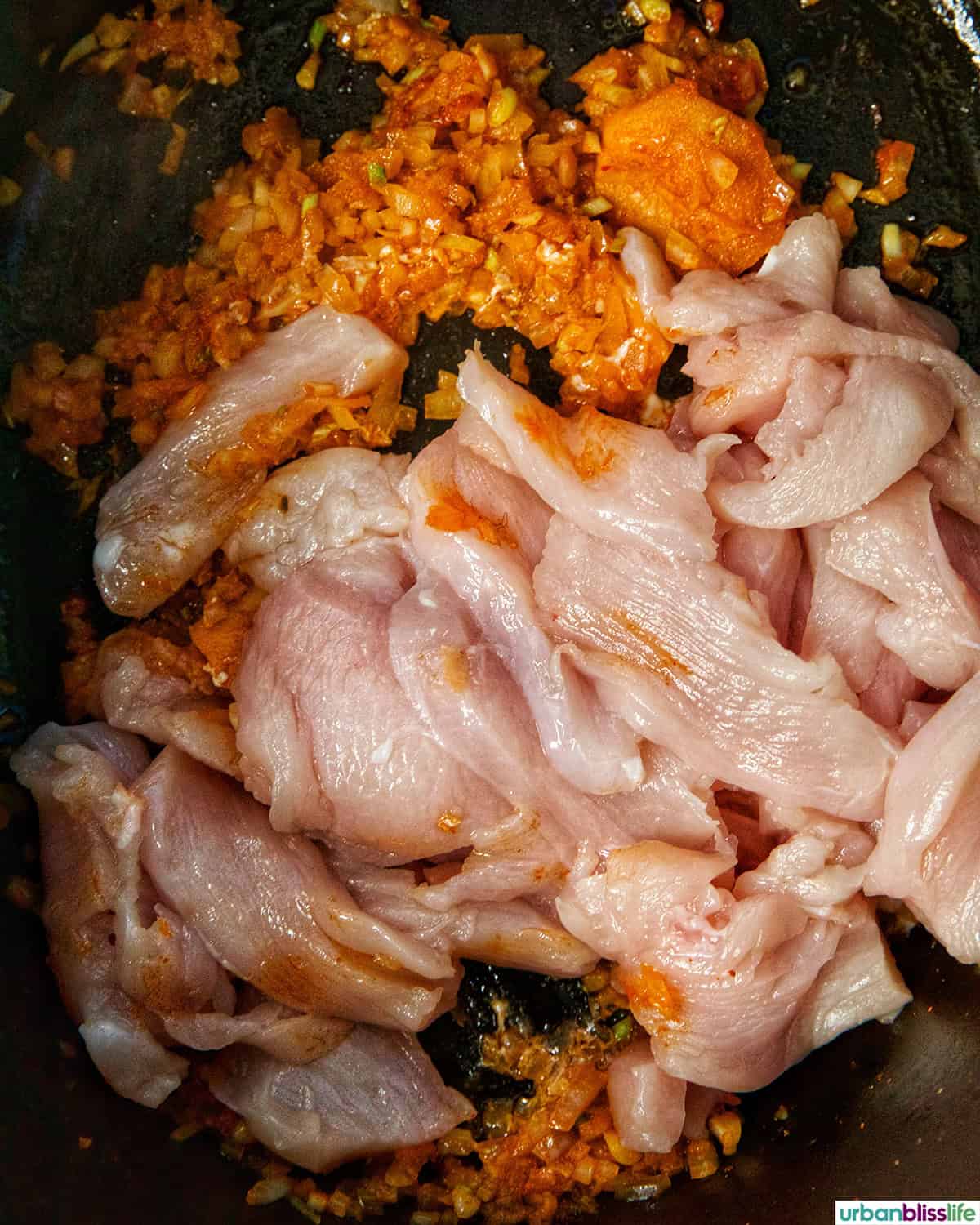 chicken seasoned and cooking in a Dutch oven.