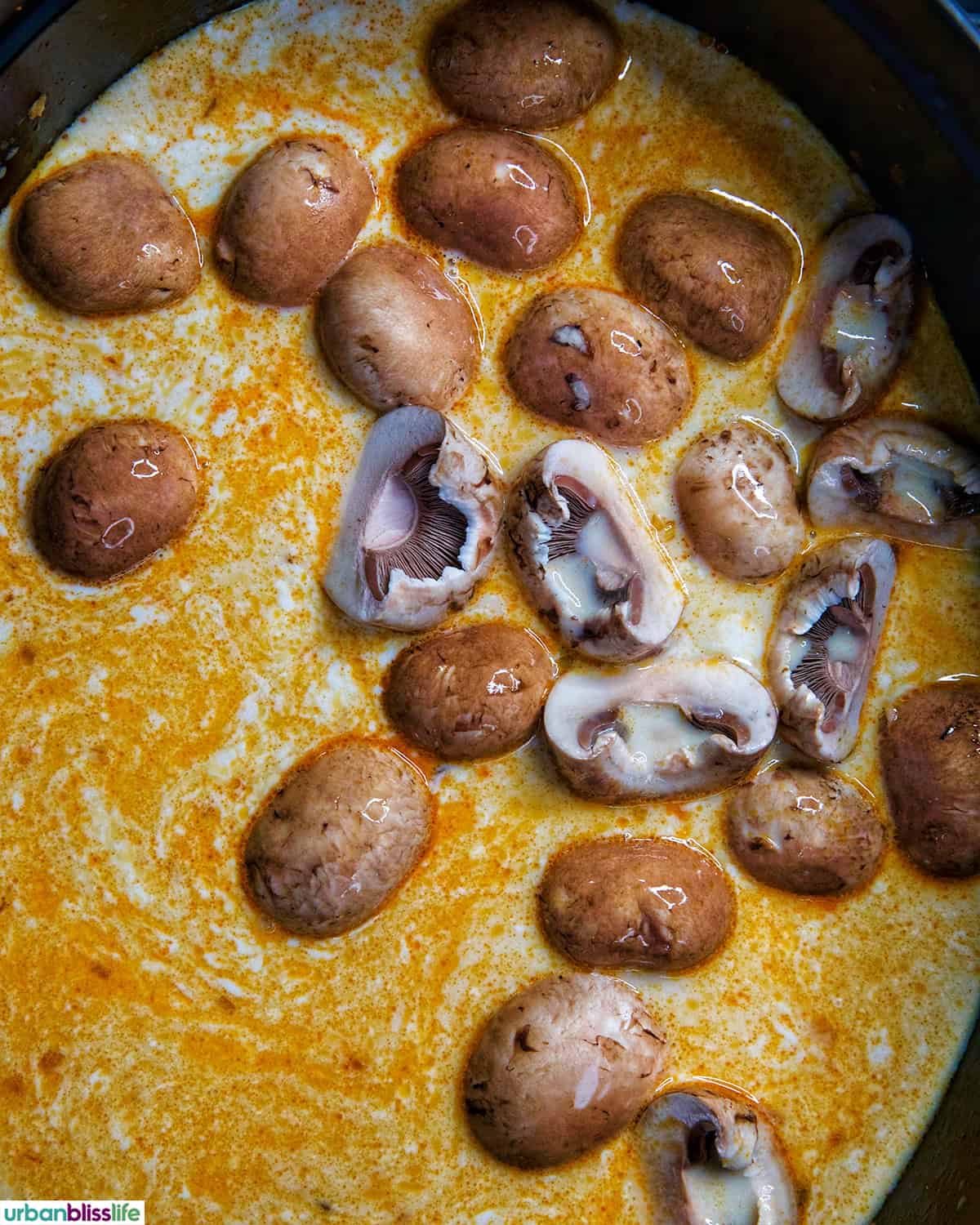 mushrooms in Dutch oven of Thai Coconut Chicken Soup (Tom Kha Gai).