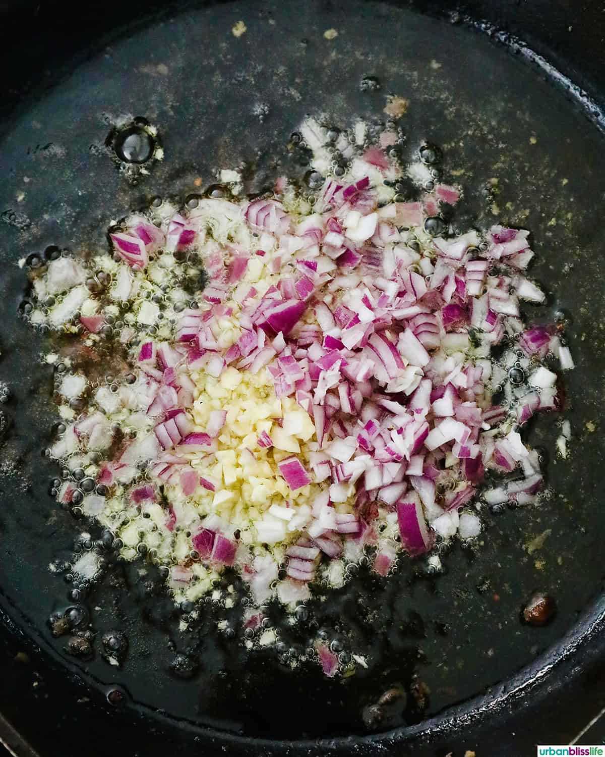 garlic and shallots and onions in a pan.