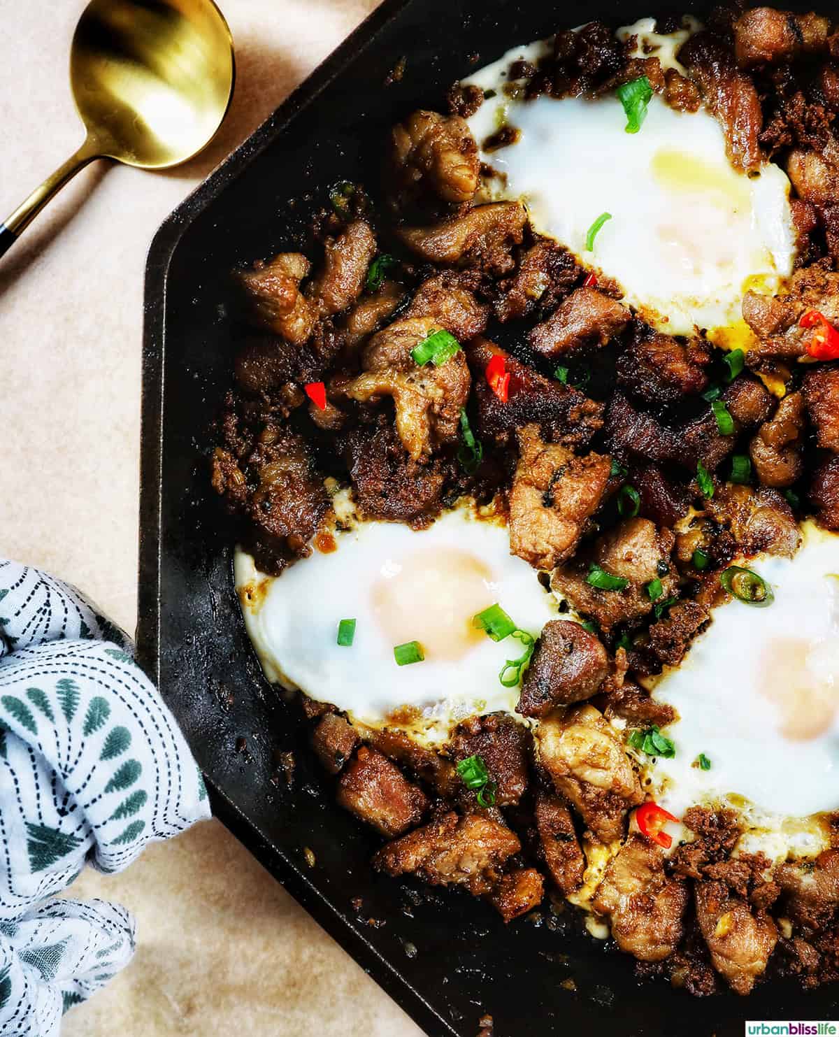 Filipino pork sisig with fried eggs on top.