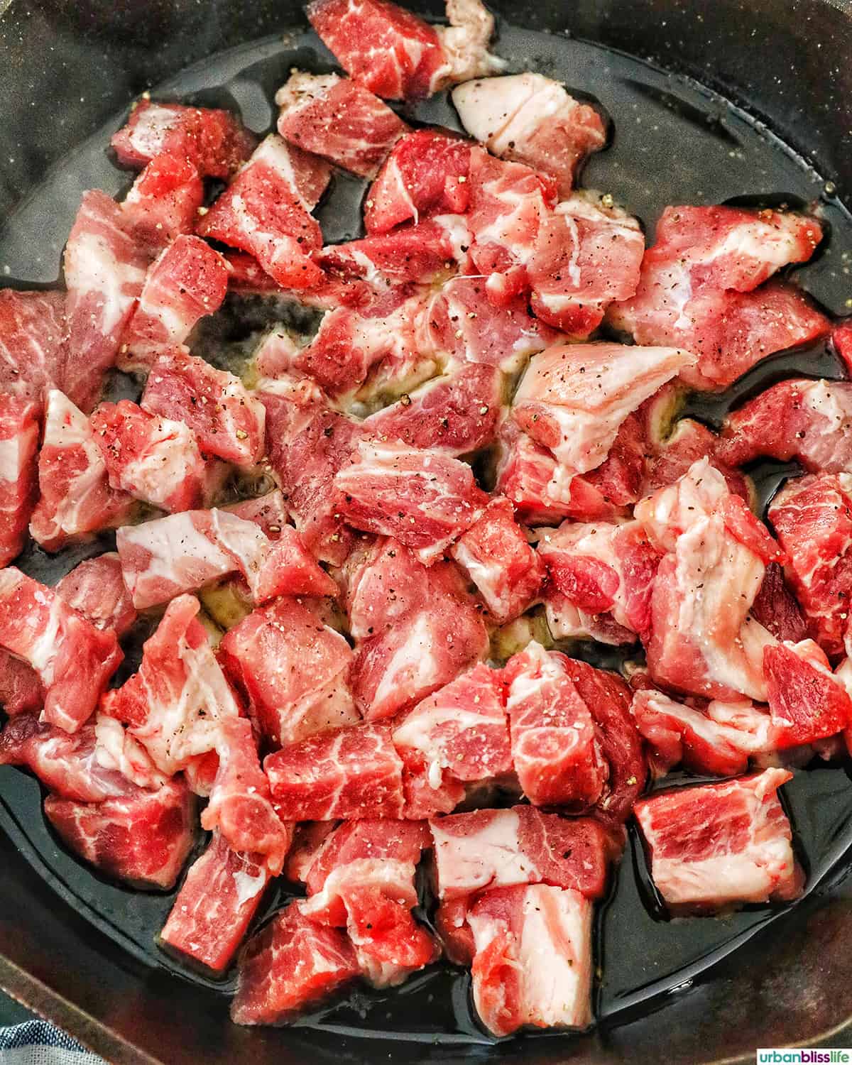 pork for Filipino pork sisig cooking in a pan.