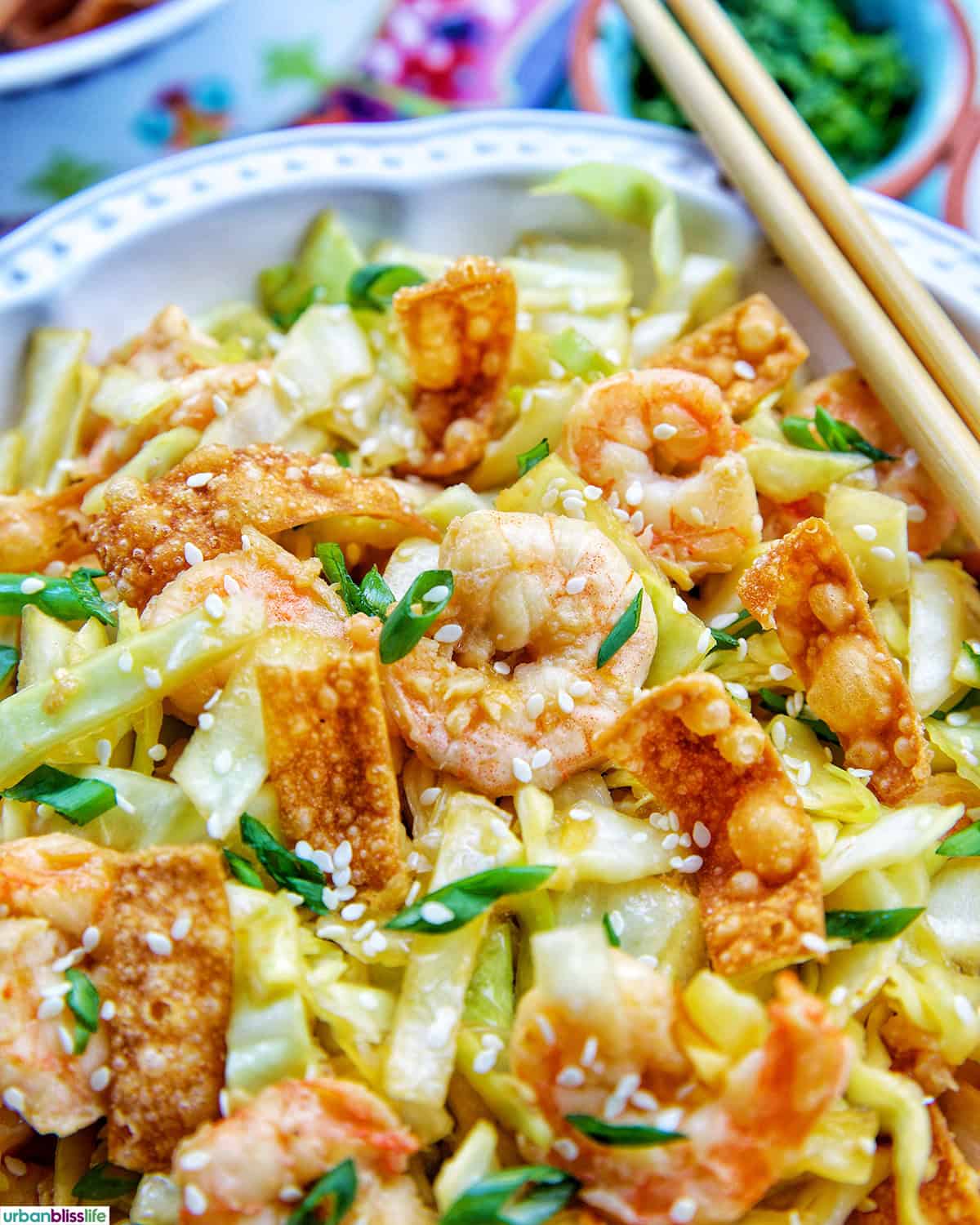bowl of cabbage and shrimp stir fry with chopsticks.