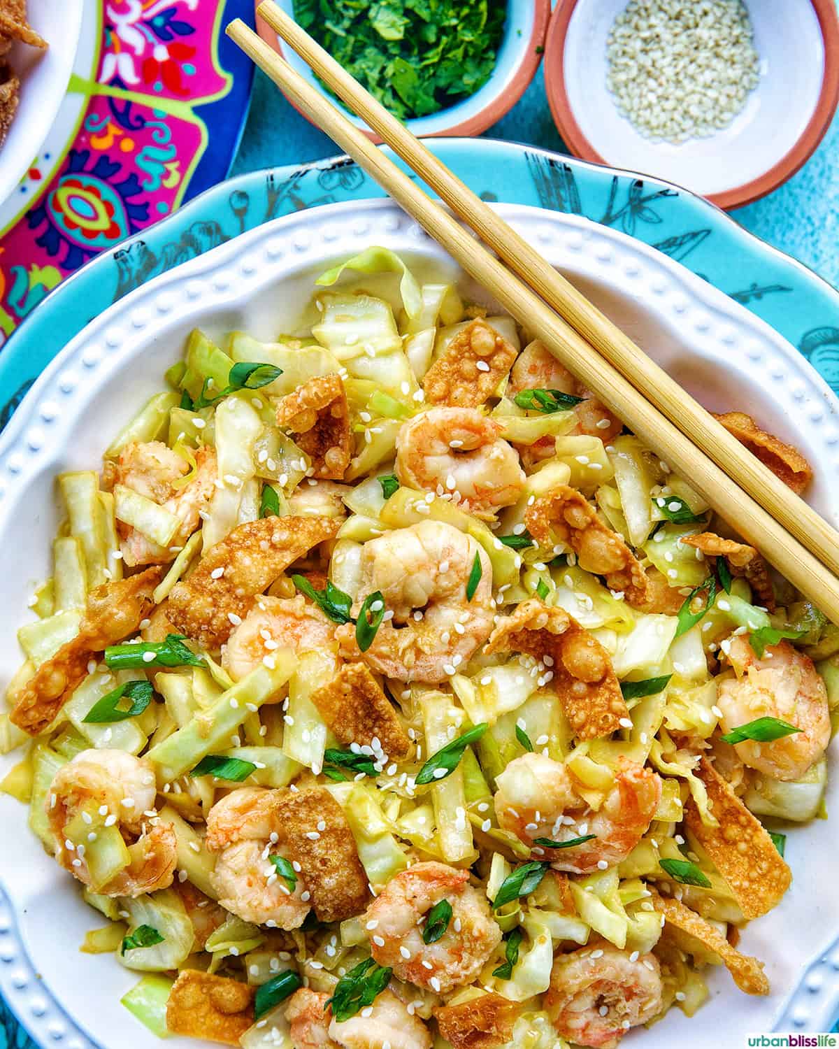 bowl of cabbage and shrimp stir fry with chopsticks.