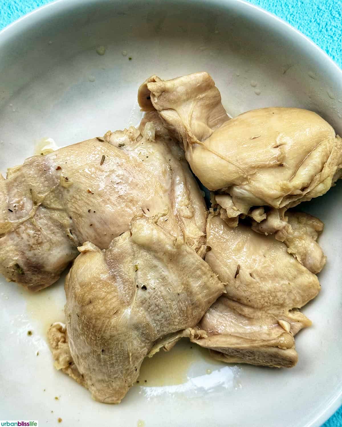 cooked chicken breasts in a bowl.