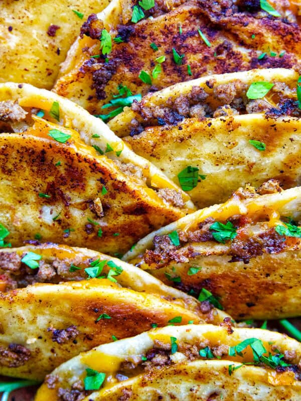 plate full of crispy beef tacos.