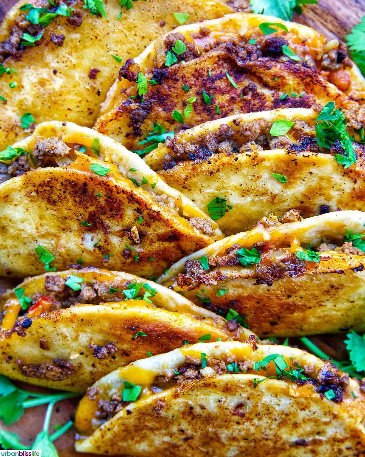plate full of crispy beef tacos.