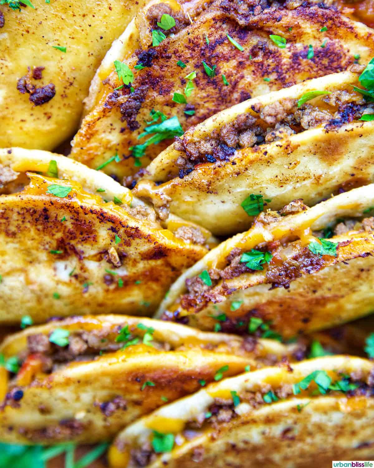 plate full of crispy beef tacos.