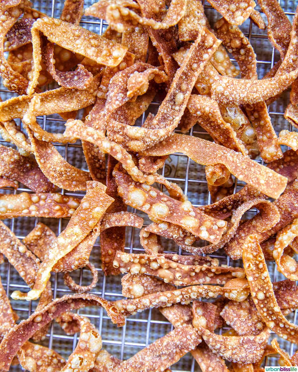 Fried Wonton Strips on a wire rack.