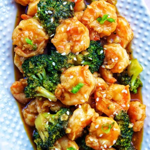shrimp and broccoli str fry on a white plate.