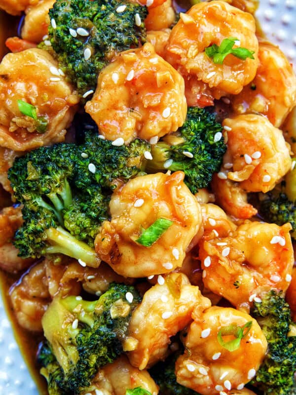 shrimp and broccoli str fry on a white plate.