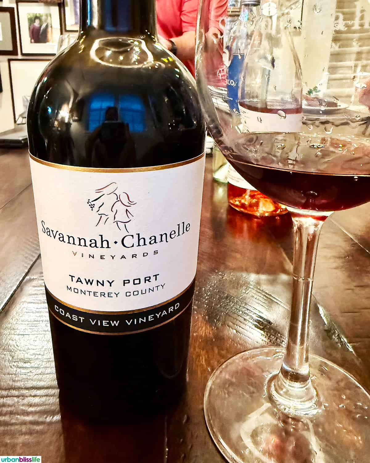 tawny port wine bottle and wine glass.