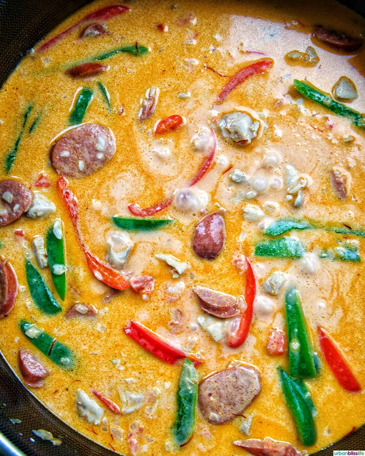 Arroz a la Valenciana cooking in a skillet.