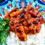colorful plate of Filipino grilled pork belly and rice.