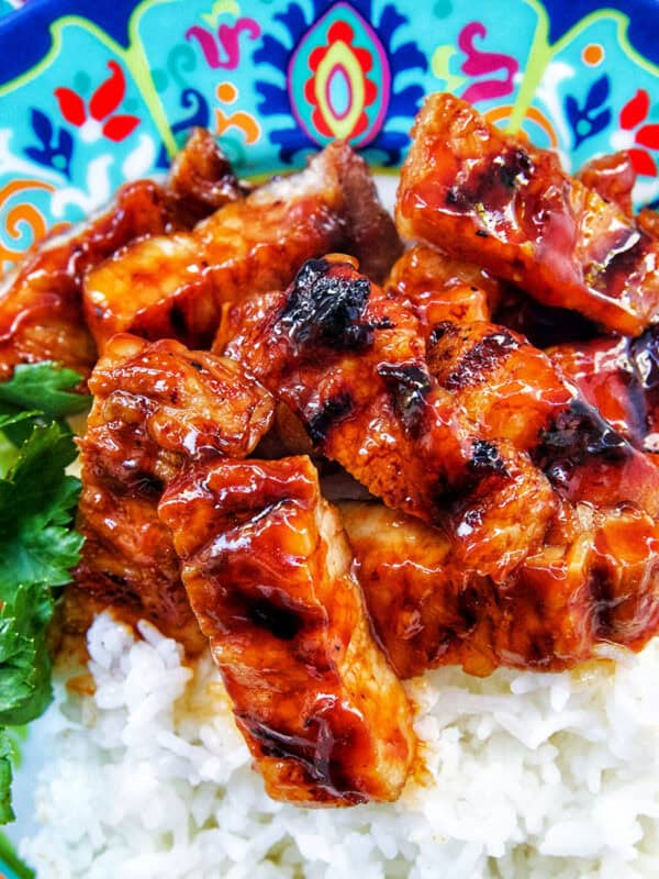 colorful plate of Filipino grilled pork belly and rice.