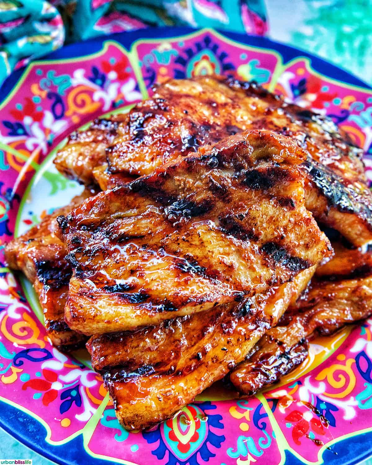 colorful plate of Filipino grilled pork belly stacked.