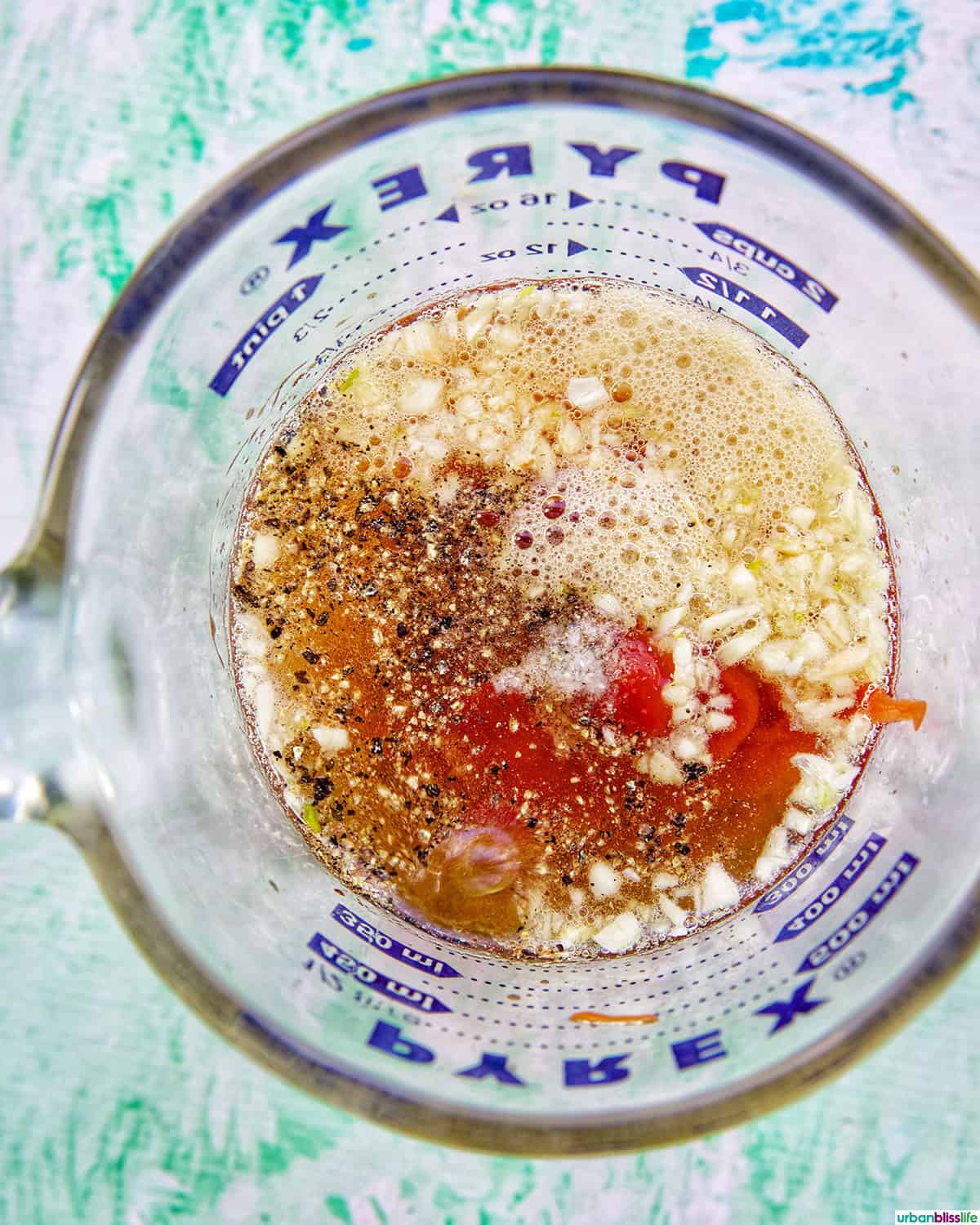ingredients in a glass measuring cup to make a marinade.