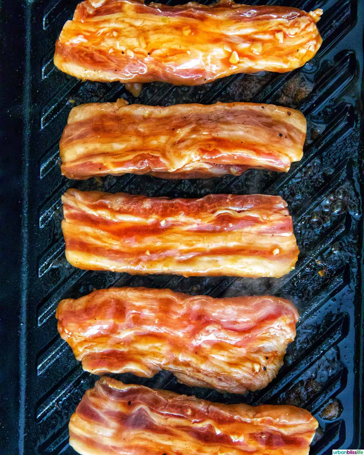 Filipino grilled pork belly on a grill pan.
