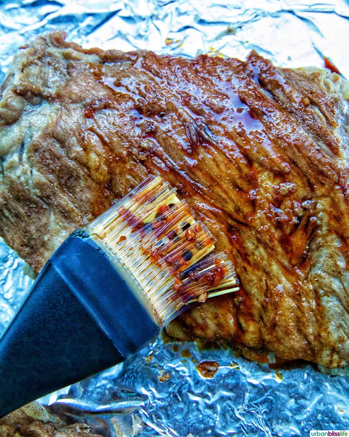 brushing Instant Pot Asian Sticky Pork Ribs with sauce.