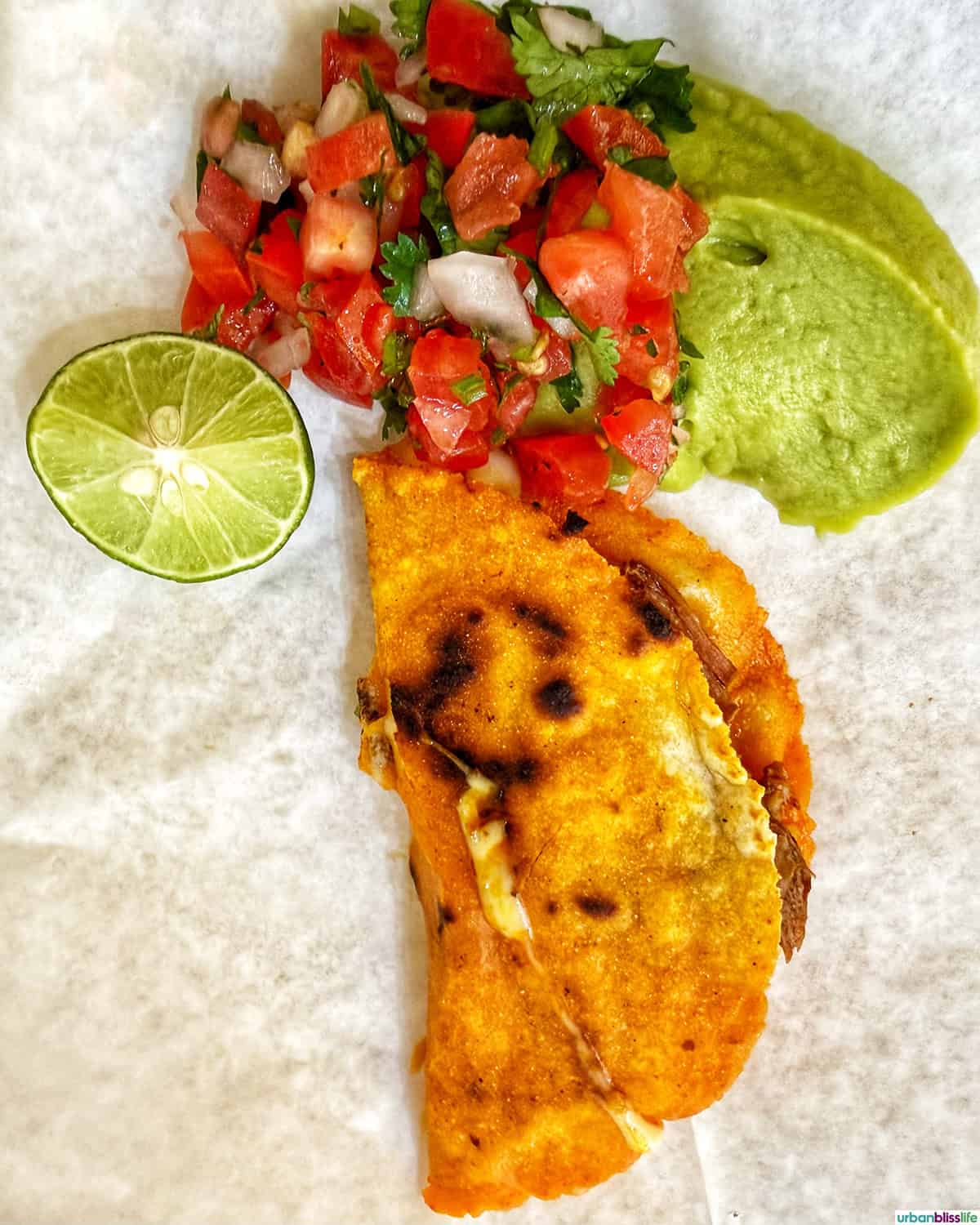 taco with lime, guac, and salsa from Taqueria Morelos in Cabo San Lucas, Mexico.