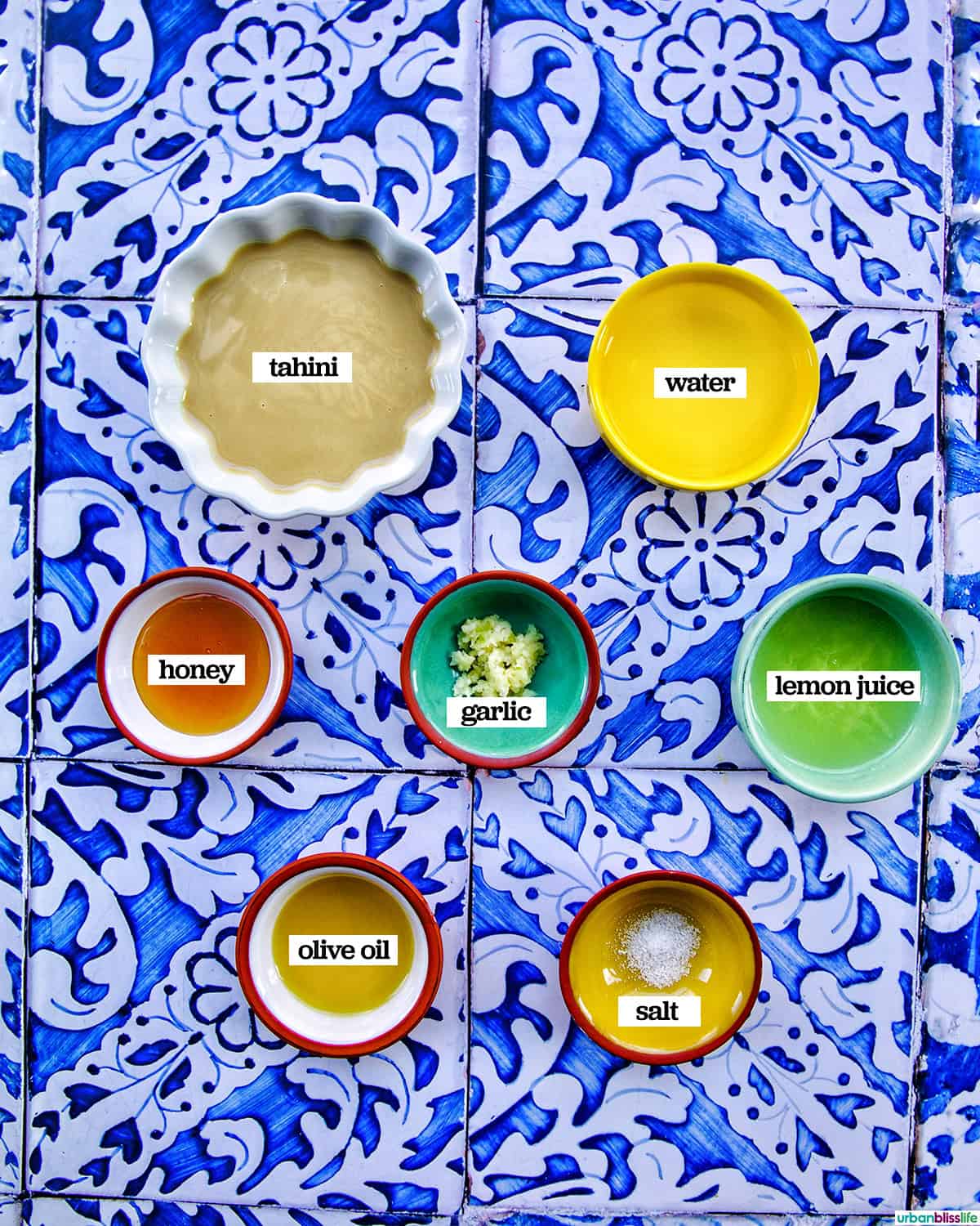 bowls of ingredients to make lemon tahini dressing.