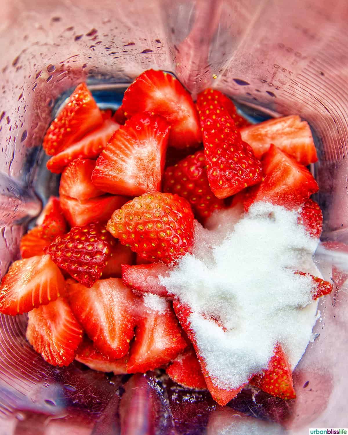 strawberries and sugar in a blender.