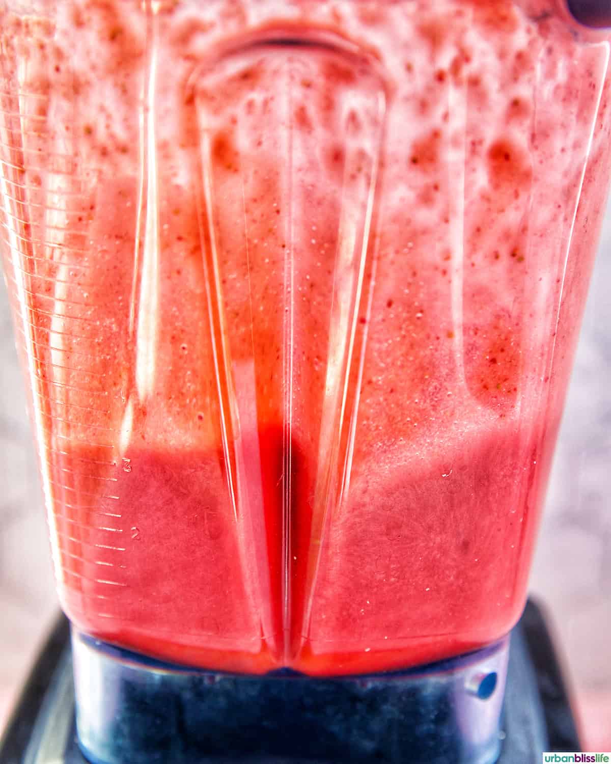 blender with strawberry popsicle mixture.