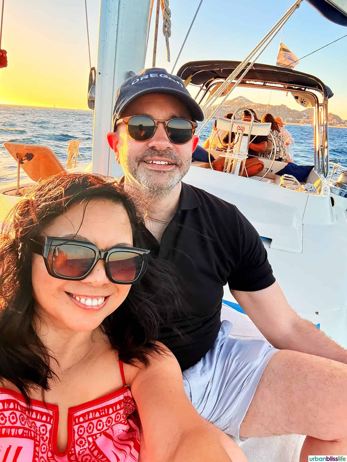 Marlynn Jayme Schotland and Alain Schotland onboard a sailboat for a sunset sail cruise in Cabo San Lucas, Mexico.