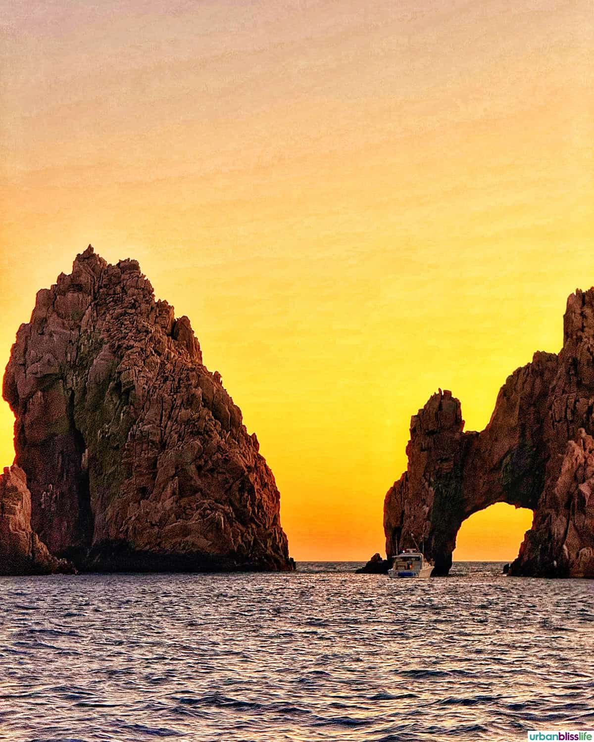 sunset view of The Arches during a sunset sail cruise in Cabo San Lucas, Mexico.