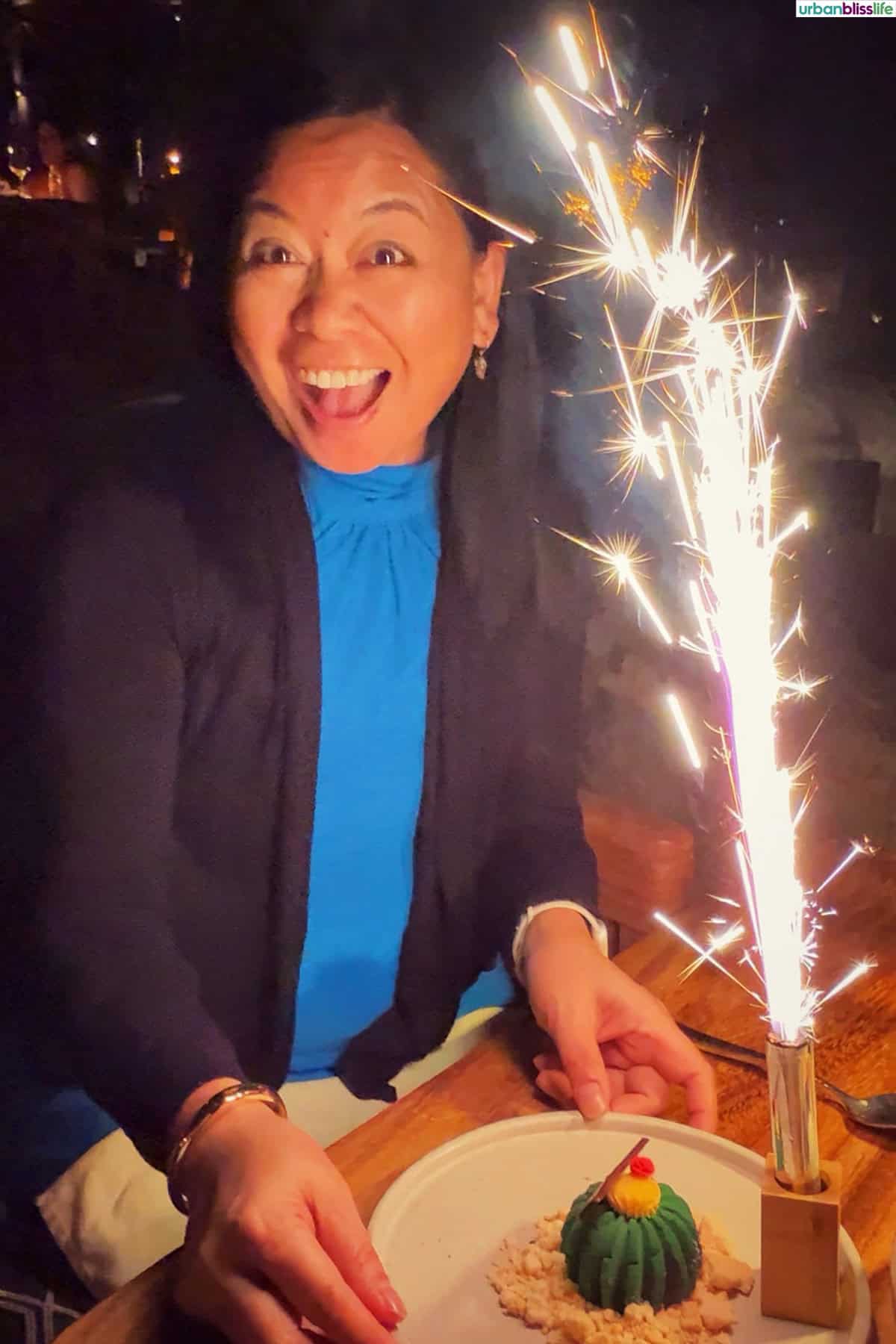 Marlynn Jayme Schotland with fireworks birthday dessert at Cocina del Mar restaurant in Cabo San Lucas, Mexico.