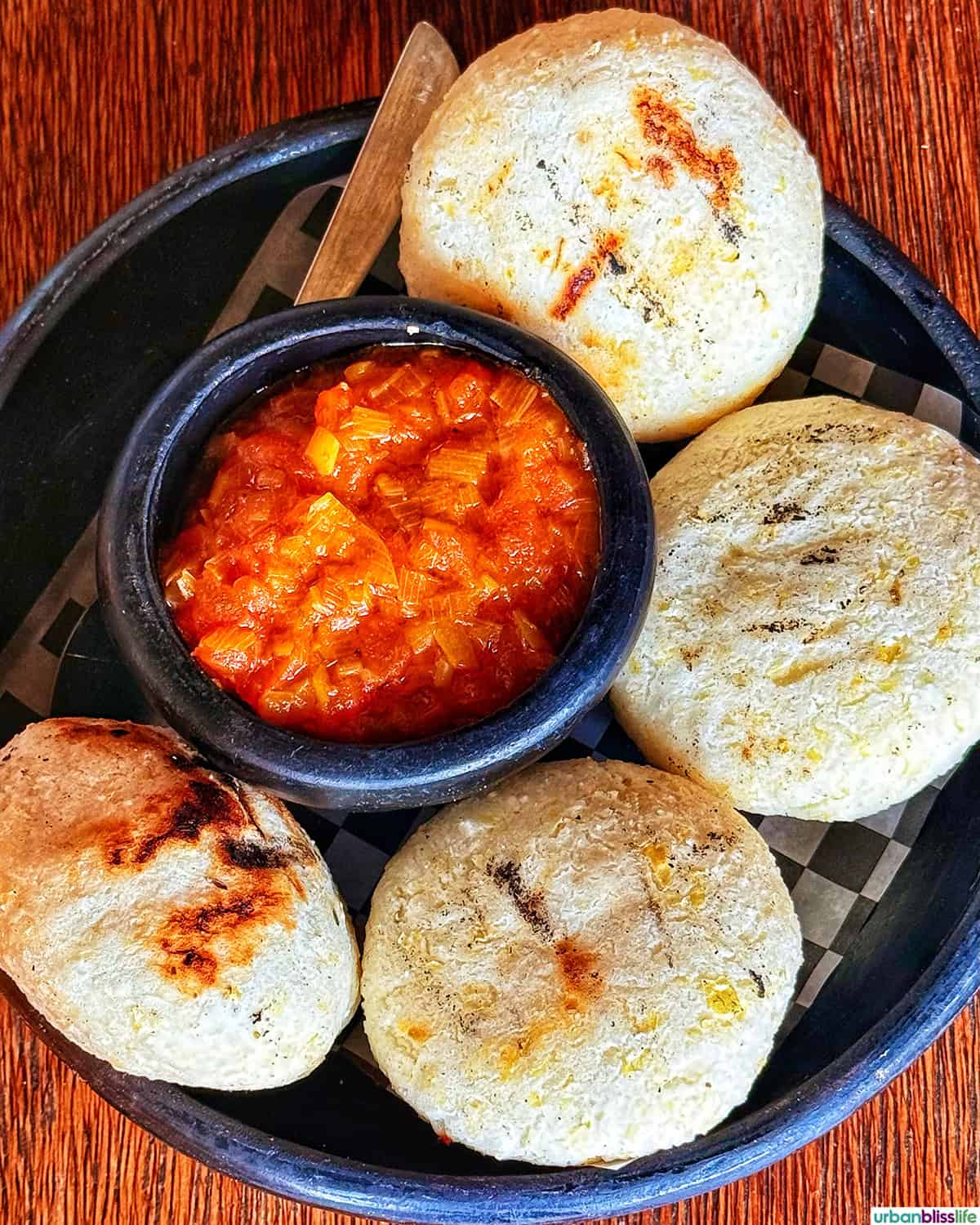 plate full of arepas and hogao, in Colombia.