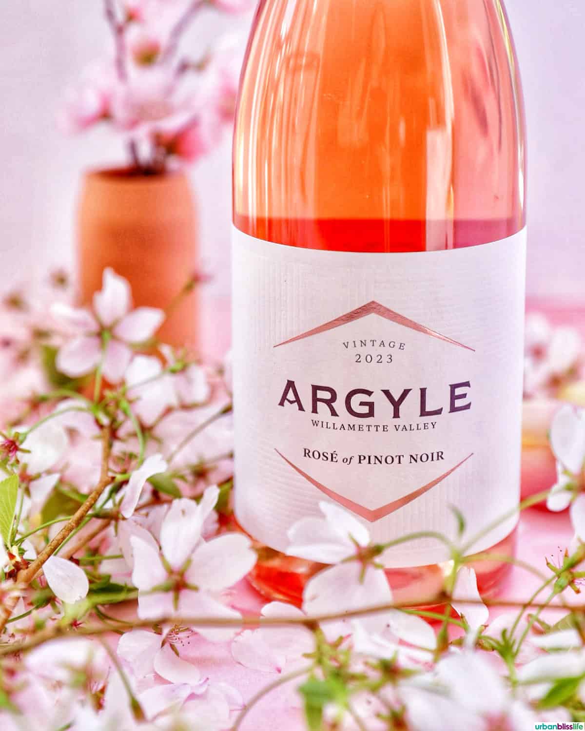 Bottle of Argyle Winery Rose of Pinot Noir wine with cherry blossoms.