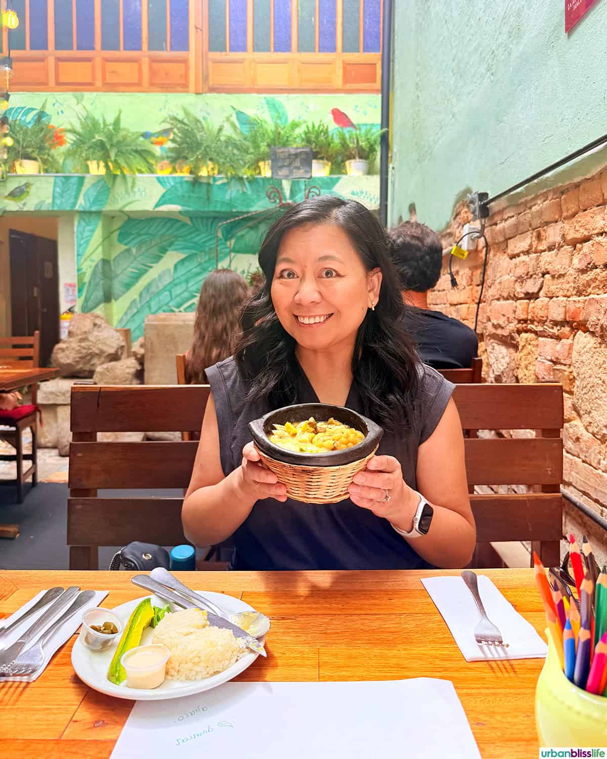 Marlynn holding a bowl of ajiaco soup in Bogota , Colombia.