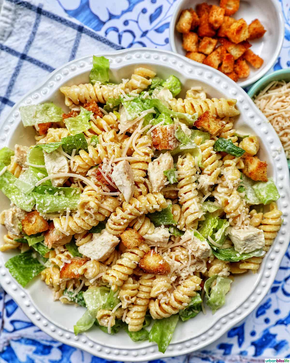 bowl of Caesar pasta salad with side of croutons.