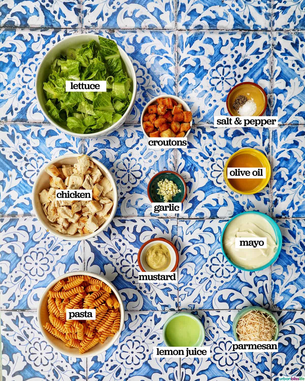 bowls of ingredients to make Caesar pasta salad.