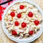 bowl of Filipino Fruit Salad topped with maraschino cherries.