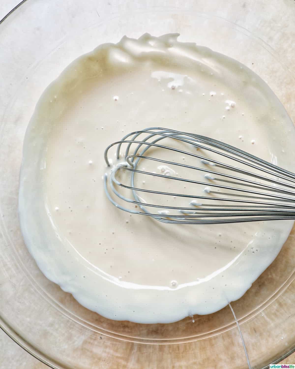 whisking together fruit salad cream.