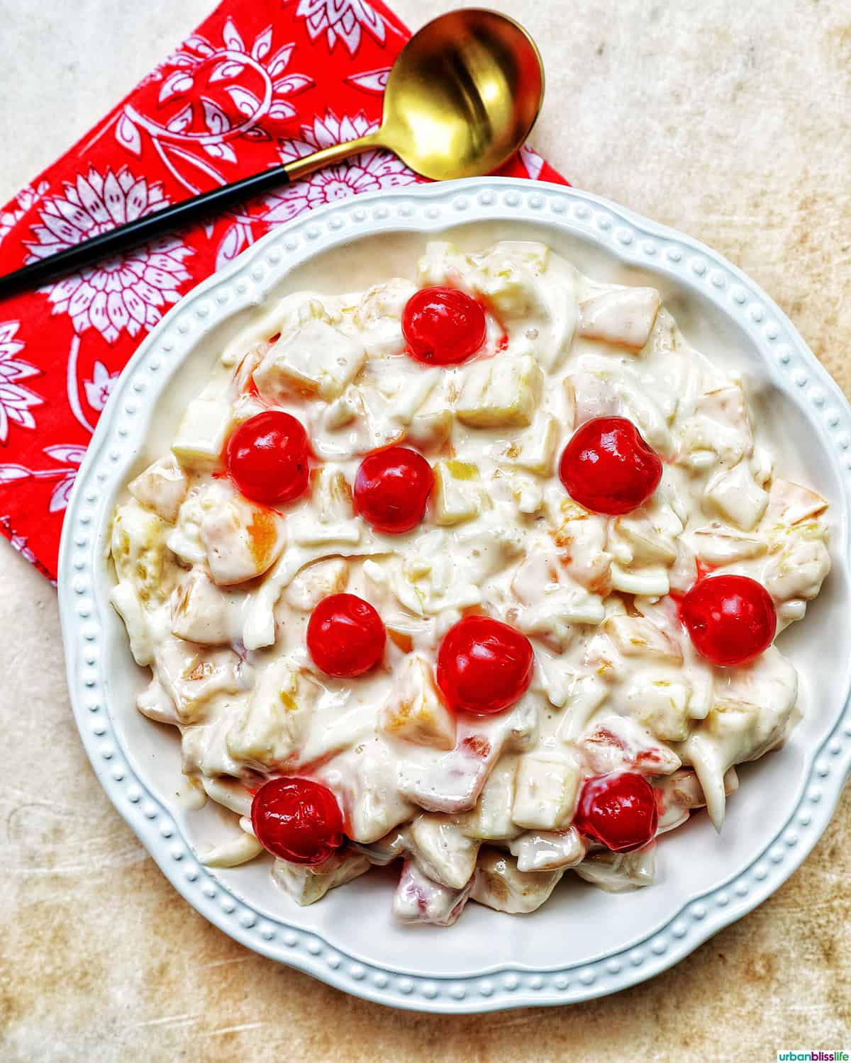 bowl of Filipino Fruit Salad topped with maraschino cherries.