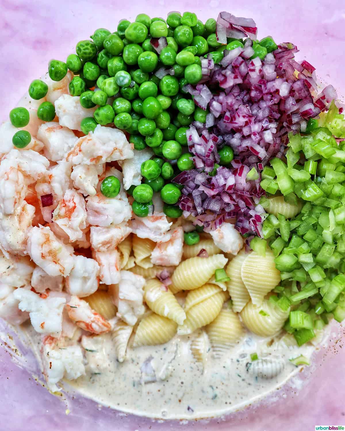 ingredients to make shrimp pasta salad in a bowl.