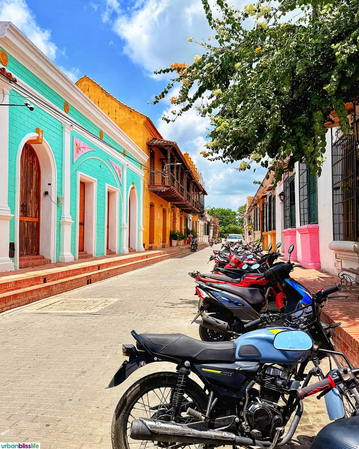 colorful buildings and motorbikes in Santa Cruz de Mompox, Colombia.