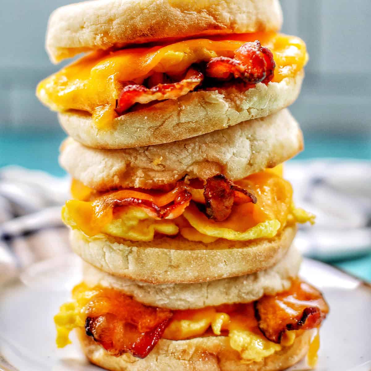stack of three air fryer breakfast sandwiches on a plate.