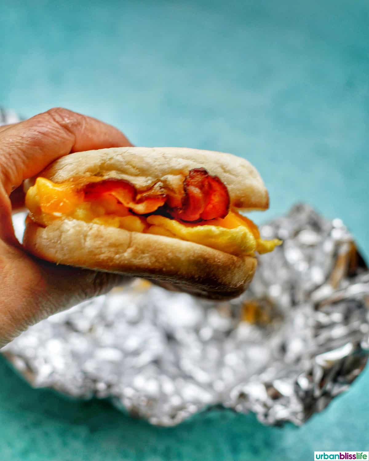 hand holding a air fryer breakfast sandwich