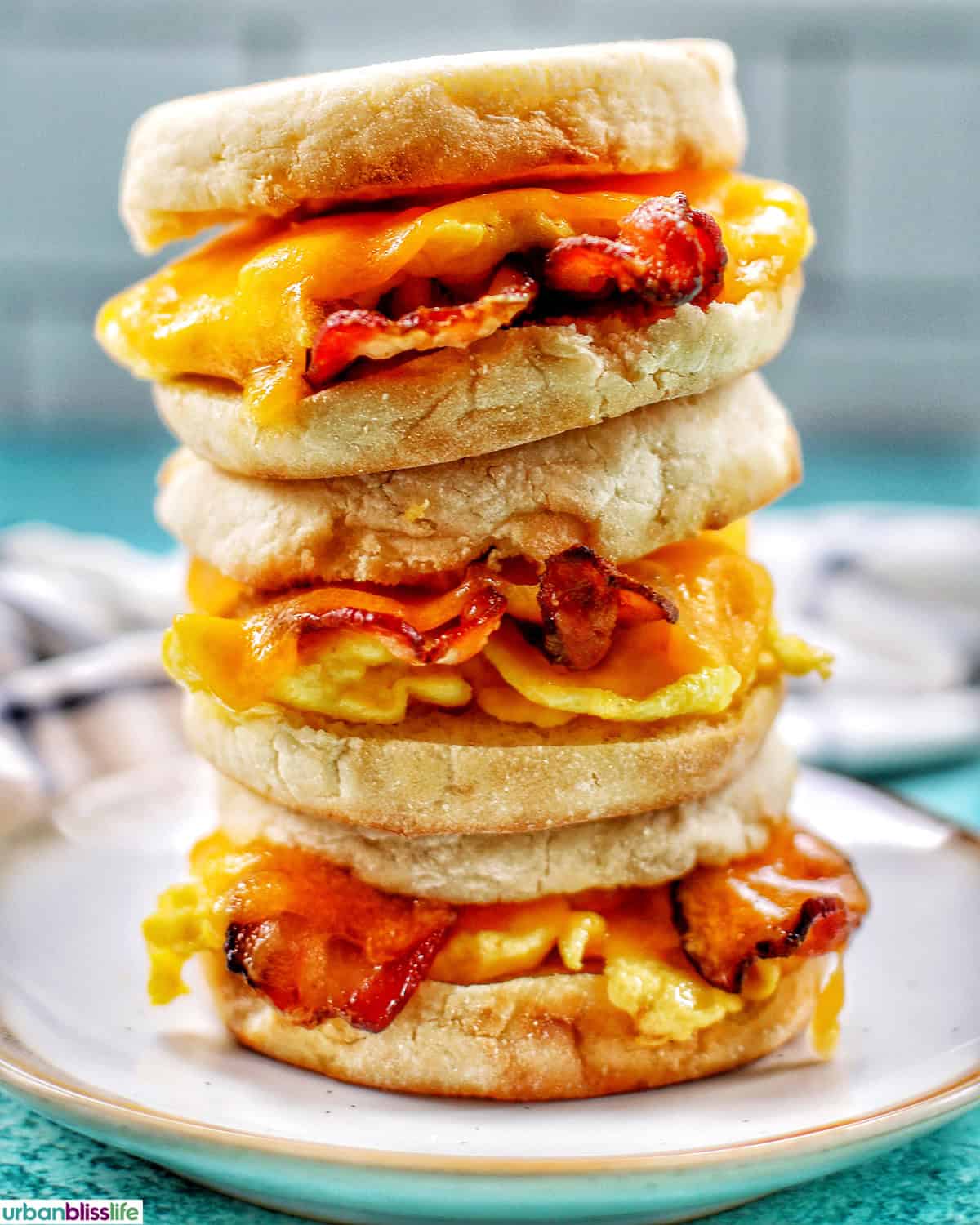 stack of three air fryer breakfast sandwiches on a plate.