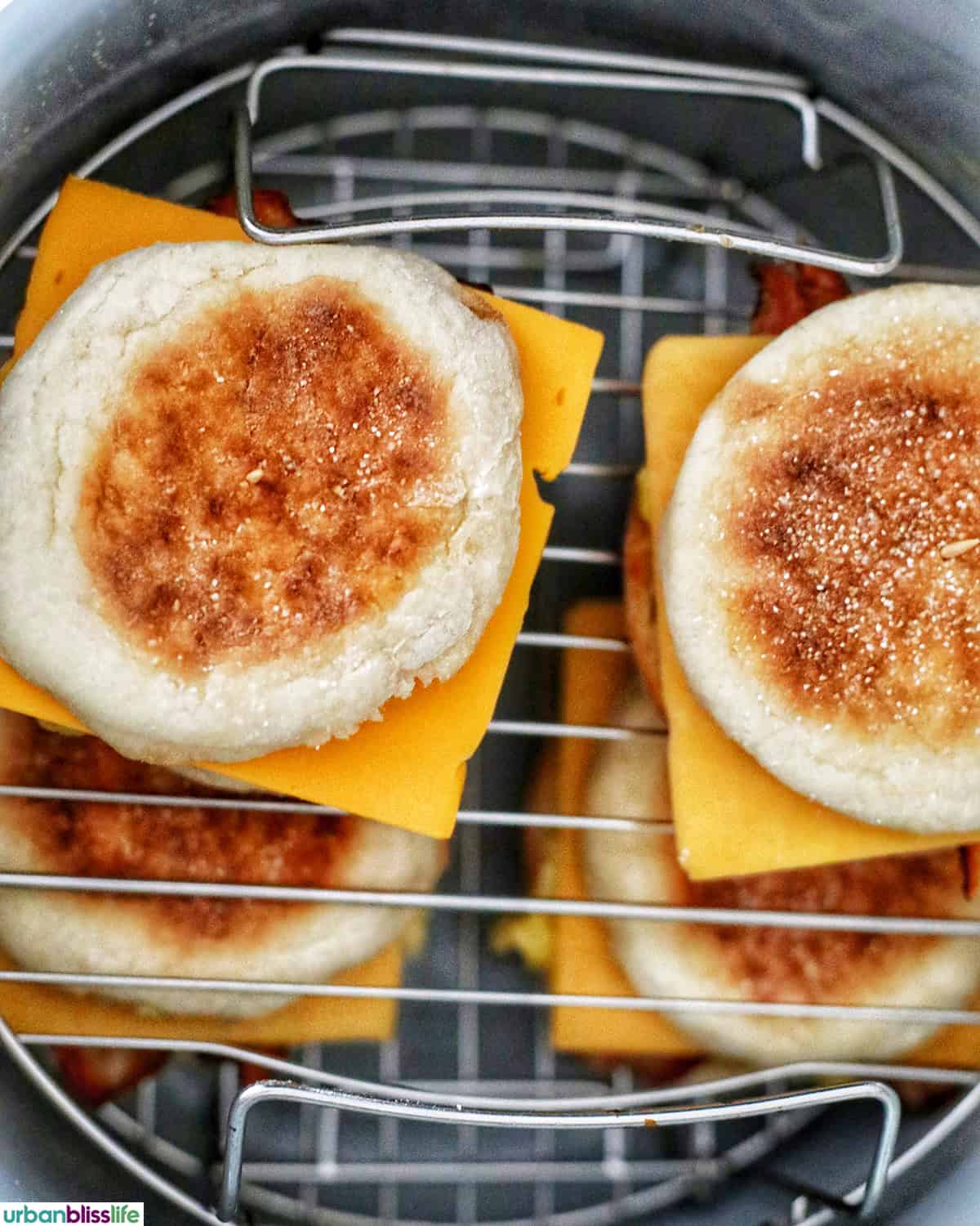 air fryer breakfast sandwiches on racks in a Ninja Instant Pot air fryer pot.
