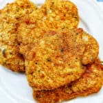 air fryer shake and bake pork chops on a plate.