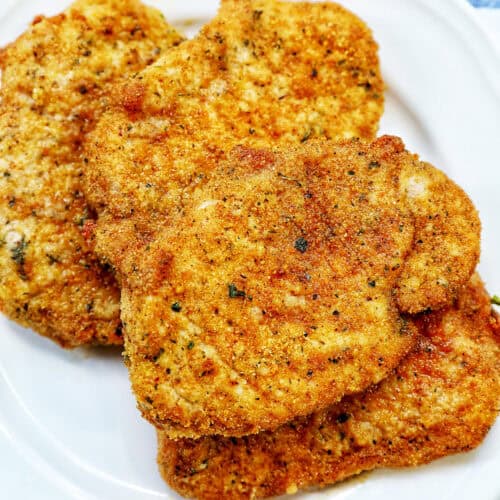 air fryer shake and bake pork chops on a plate.