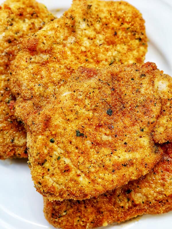 air fryer shake and bake pork chops on a plate.