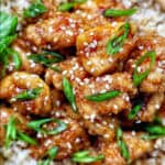 Air fryer teriyaki chicken over brown rice with herbs and chopsticks.