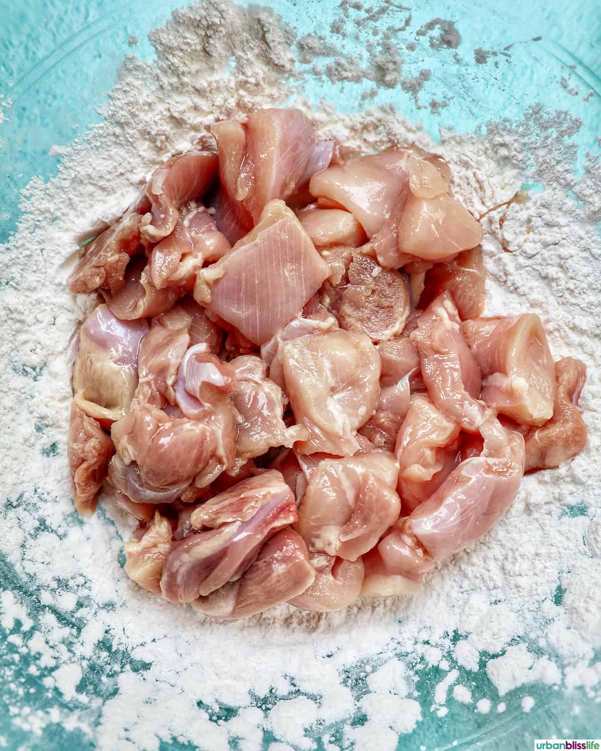 chicken pieces over tapioca starch breading in a bowl.