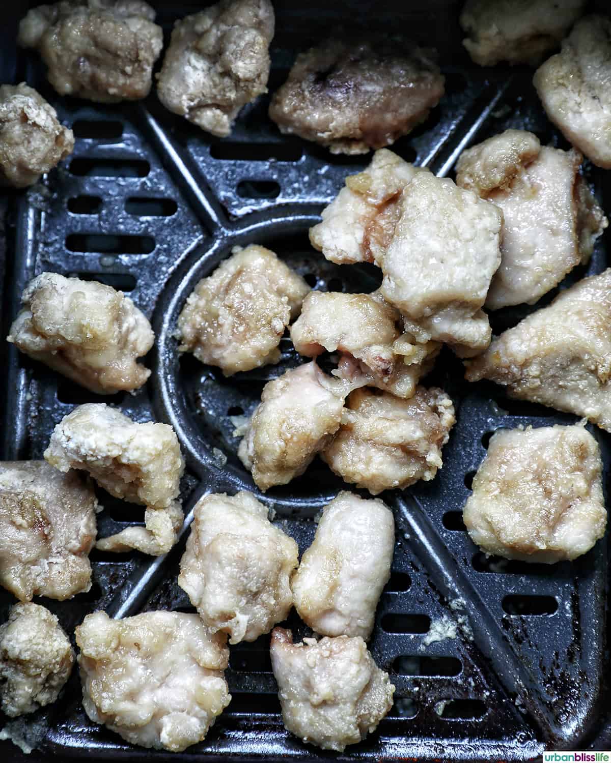 air fryer teriyaki chicken in an air fryer basket.