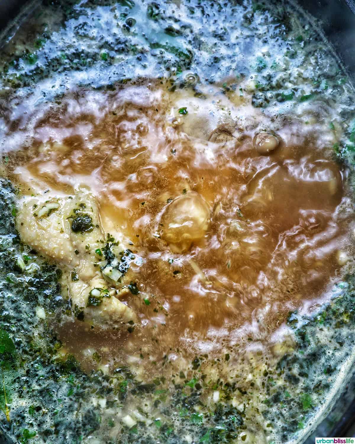 Colombian ajiaco soup cooking in a dutch oven.